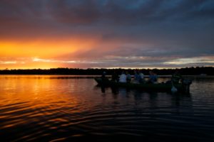 A motor canoe at sunset on the Rio Negro.