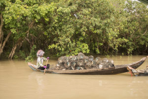 A fisherwoman setting traps on the lake