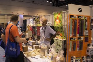 Julian Sprung of Two Little Fishies discussing some new products with customers