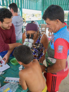 Aquarium fish collectors were able to take a hands-on approach to learning more about the fish they rely on for their livelihoods. Here, a fisher peers into a microscope to get a closer look at the gills of a sick fish.