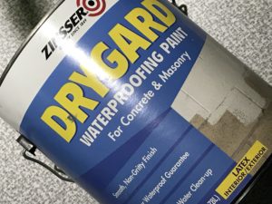 One-gallon (3.8 liter) can of Zinsser® DRYGARD™. This DRYGARD™ formulation was selected among a few different options as a waterproofer paint with added mold or mildew inhibitors.