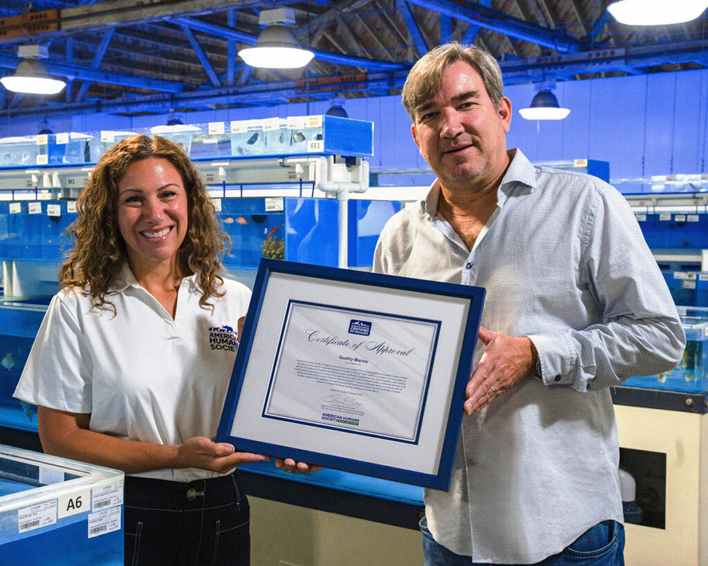 Chris Buerner (right), President and Owner of Quality Marine, receiving the Certificate of Approval from the American Humane Society.